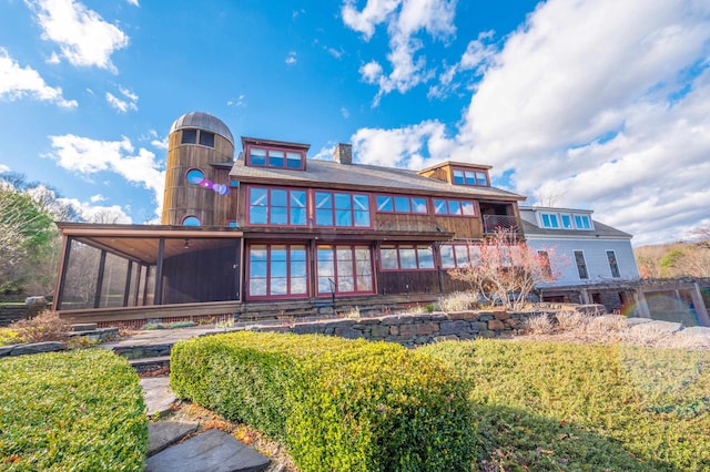 back of house with a sunroom