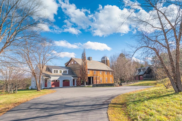 view of front of house with a front yard and a garage