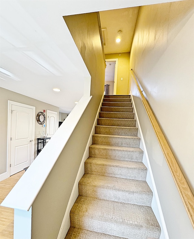 stairs with hardwood / wood-style floors