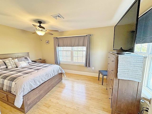 bedroom with ceiling fan and light hardwood / wood-style flooring