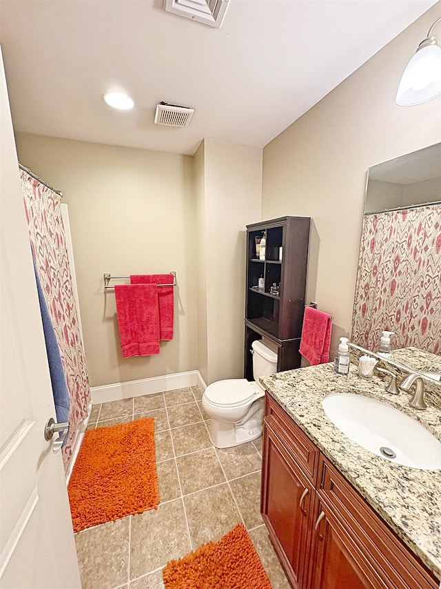 bathroom featuring tile patterned floors, vanity, and toilet