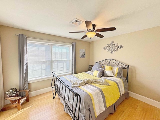 bedroom with light hardwood / wood-style flooring and ceiling fan