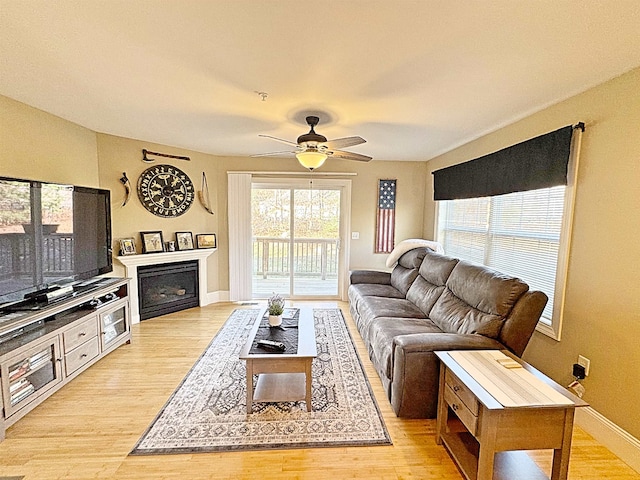 living room featuring light hardwood / wood-style floors and ceiling fan