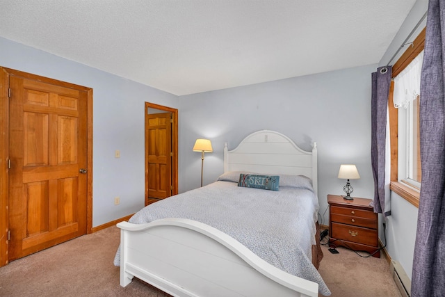 carpeted bedroom featuring a textured ceiling and a baseboard radiator