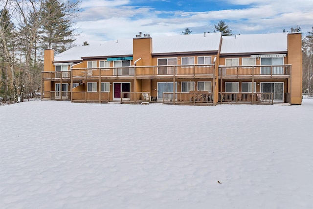 view of snow covered rear of property