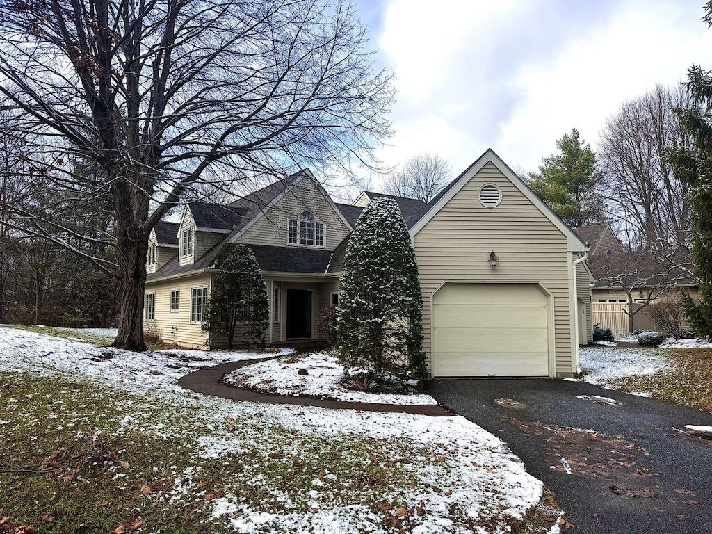 cape cod home with a garage