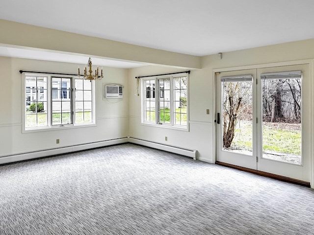 carpeted spare room featuring an inviting chandelier and a wall unit AC