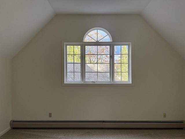 additional living space with lofted ceiling, baseboard heating, and carpet