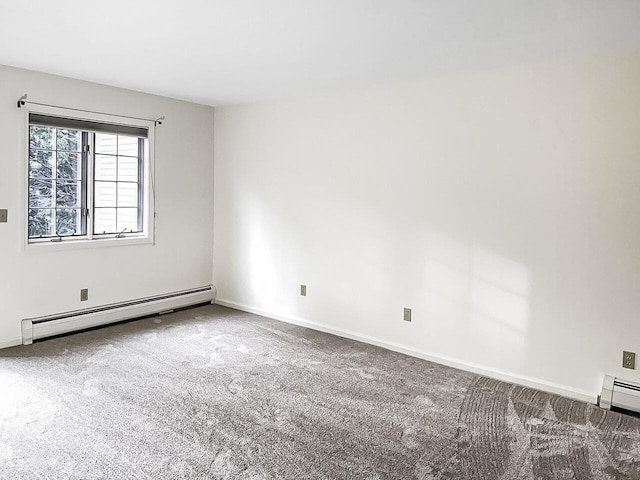 unfurnished room with baseboard heating and carpet