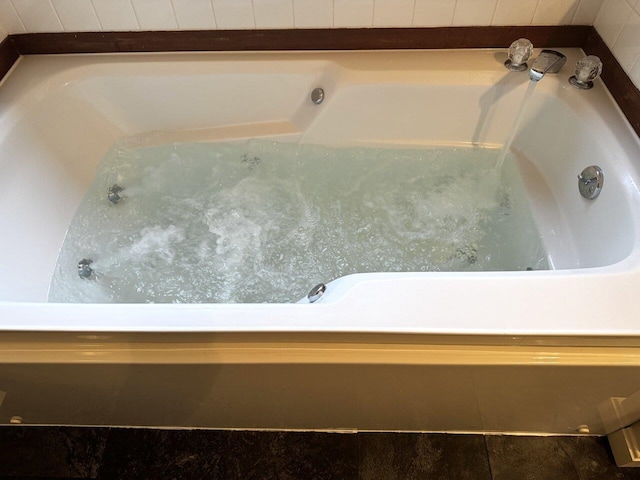 room details with a tub to relax in and a hot tub