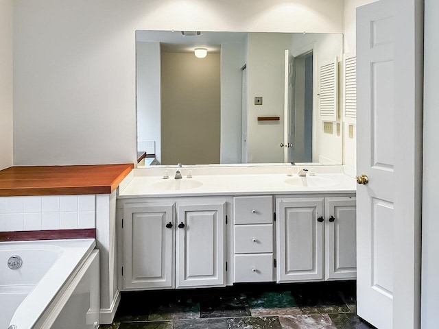 bathroom featuring vanity and a tub