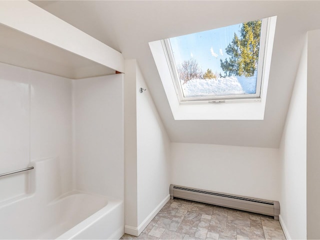 bathroom with a skylight and a baseboard radiator