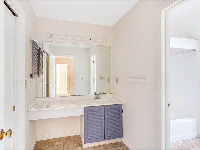 bathroom with vanity and a washtub