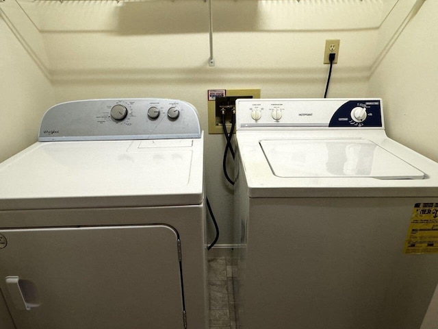 clothes washing area with washing machine and dryer