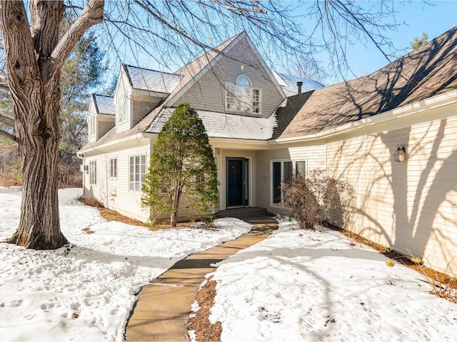 view of snow covered rear of property