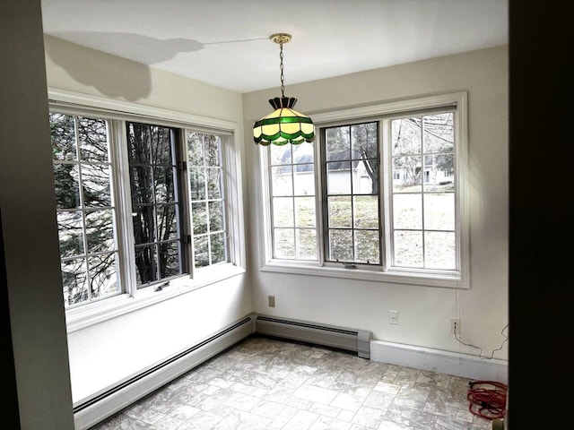 dining area with a healthy amount of sunlight and baseboard heating