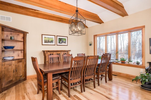 dining area with vaulted ceiling with beams, light wood-type flooring, and an inviting chandelier