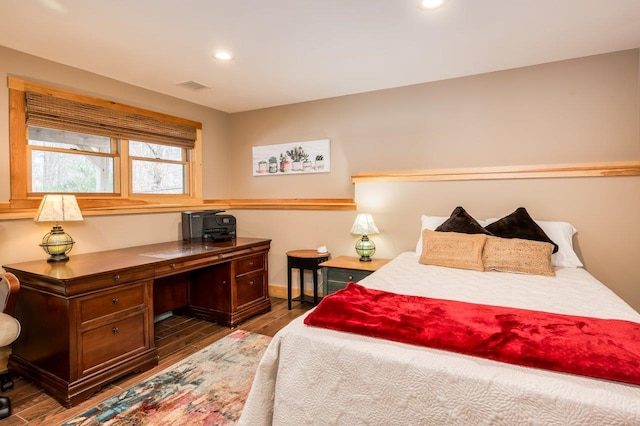 bedroom with dark hardwood / wood-style flooring