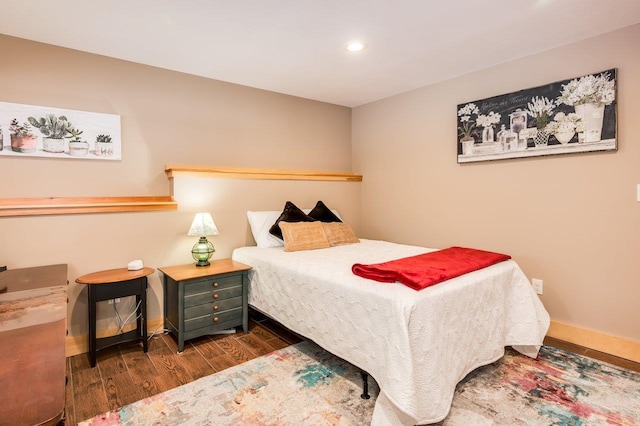 bedroom with dark wood-type flooring