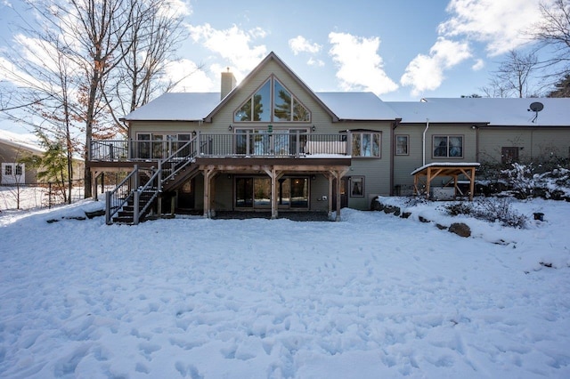 snow covered property featuring a deck