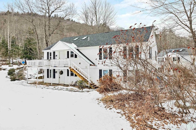 snow covered property with a wooden deck