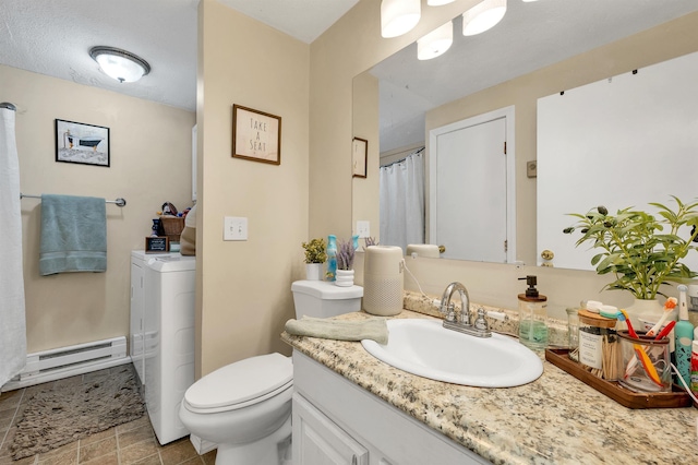 bathroom with toilet, a baseboard heating unit, vanity, and washer / dryer