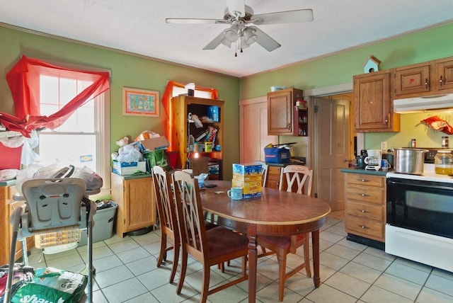 tiled dining space with ceiling fan