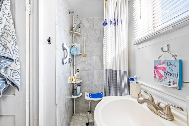 bathroom with tile patterned flooring, a shower with curtain, and sink