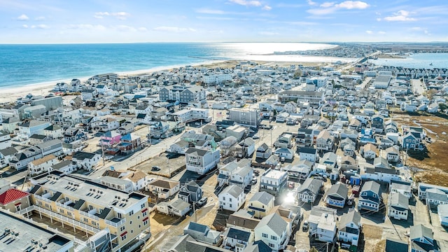 drone / aerial view with a beach view and a water view