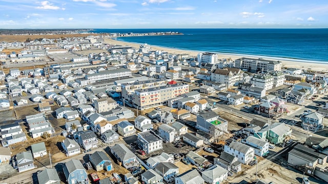 drone / aerial view featuring a beach view and a water view