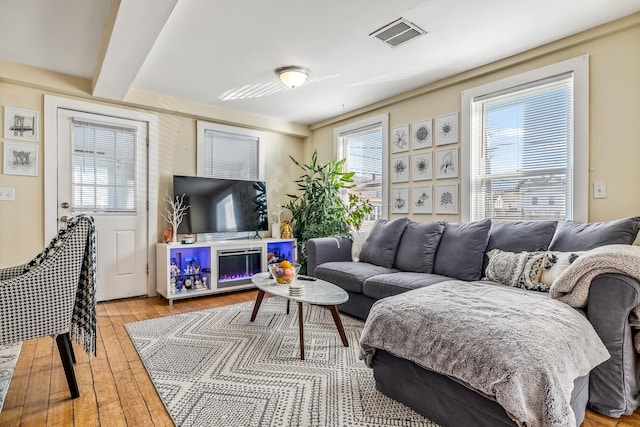 living room featuring hardwood / wood-style floors and beamed ceiling