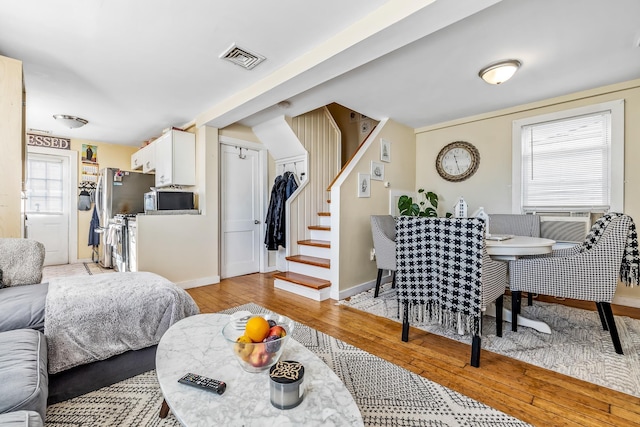 7 Perkins Ave Unit A, Hampton, NH 03842 - living room featuring light wood-style floors, baseboards, and stairs