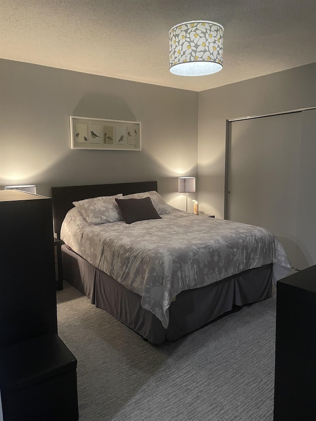 carpeted bedroom with a textured ceiling