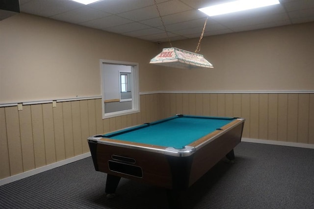 game room with a paneled ceiling, wood walls, dark carpet, and pool table