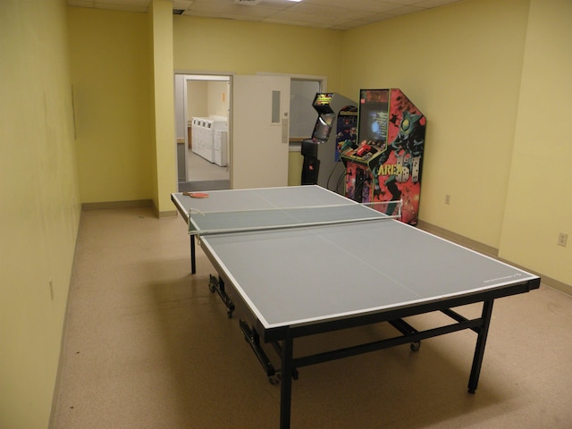 recreation room featuring a paneled ceiling and washing machine and dryer