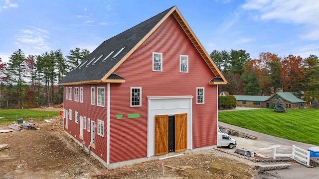 view of side of home with a yard