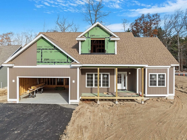 view of front of home featuring covered porch and a garage