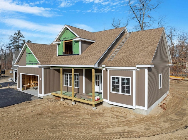 view of front of home featuring covered porch and a garage