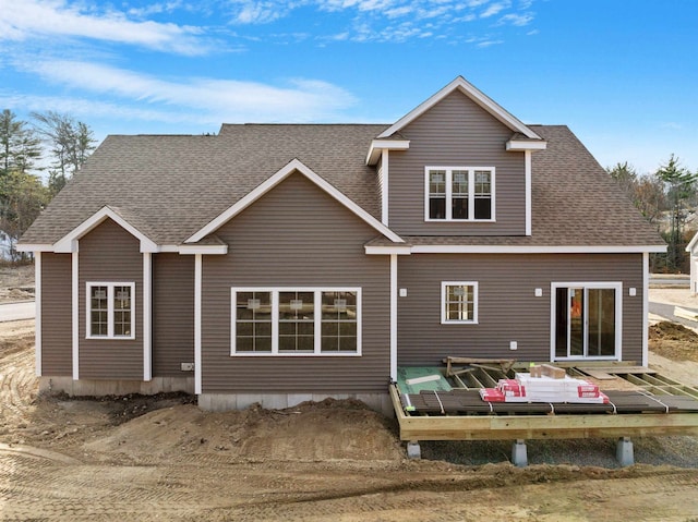 rear view of property with a wooden deck