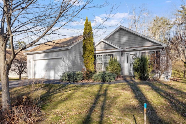 ranch-style home featuring a garage and a front lawn