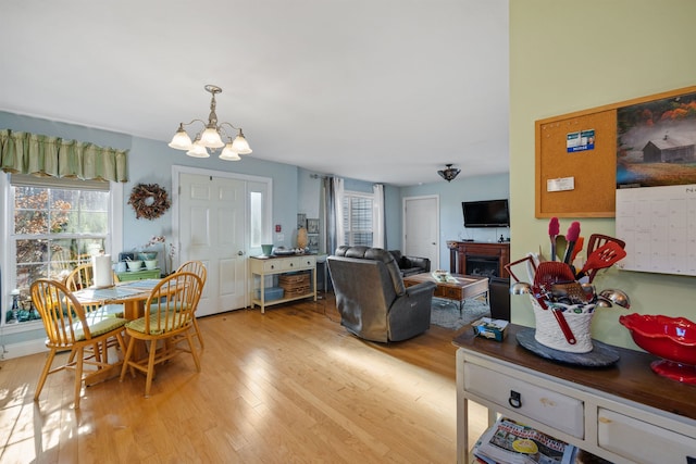 dining space with a notable chandelier and light hardwood / wood-style floors