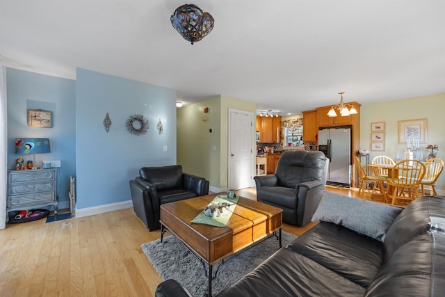 living room featuring a chandelier and light hardwood / wood-style floors