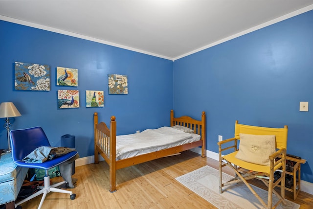 bedroom featuring crown molding and hardwood / wood-style flooring