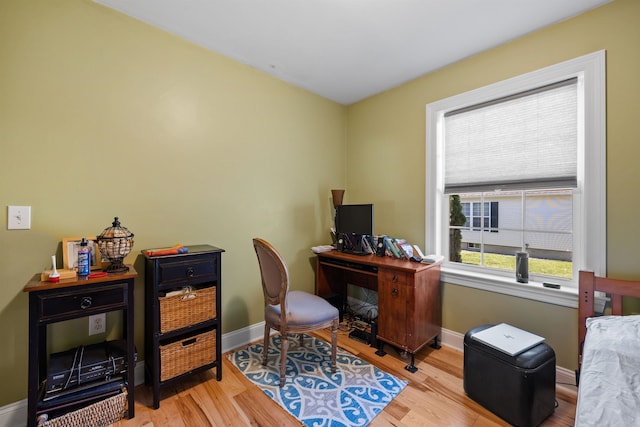 office with a healthy amount of sunlight and light hardwood / wood-style floors