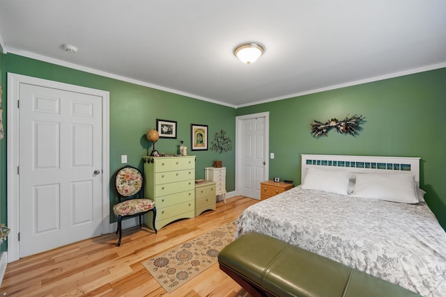 bedroom featuring wood-type flooring and crown molding