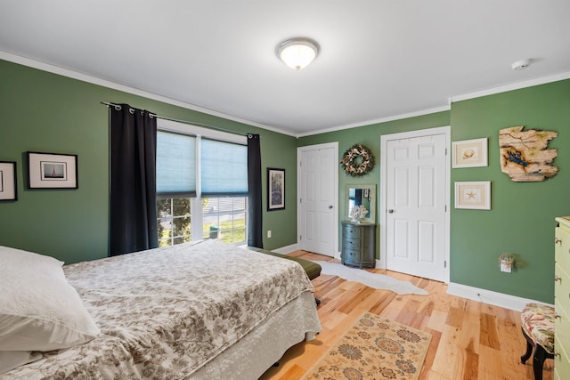 bedroom with light hardwood / wood-style floors and ornamental molding