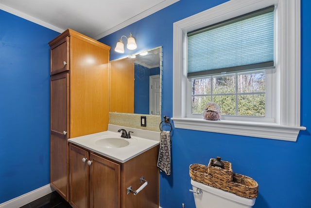 bathroom featuring vanity, toilet, and ornamental molding