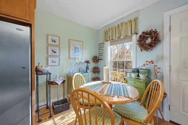 dining space with light hardwood / wood-style flooring