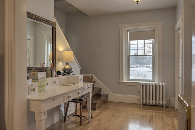 home office featuring radiator heating unit and light hardwood / wood-style floors