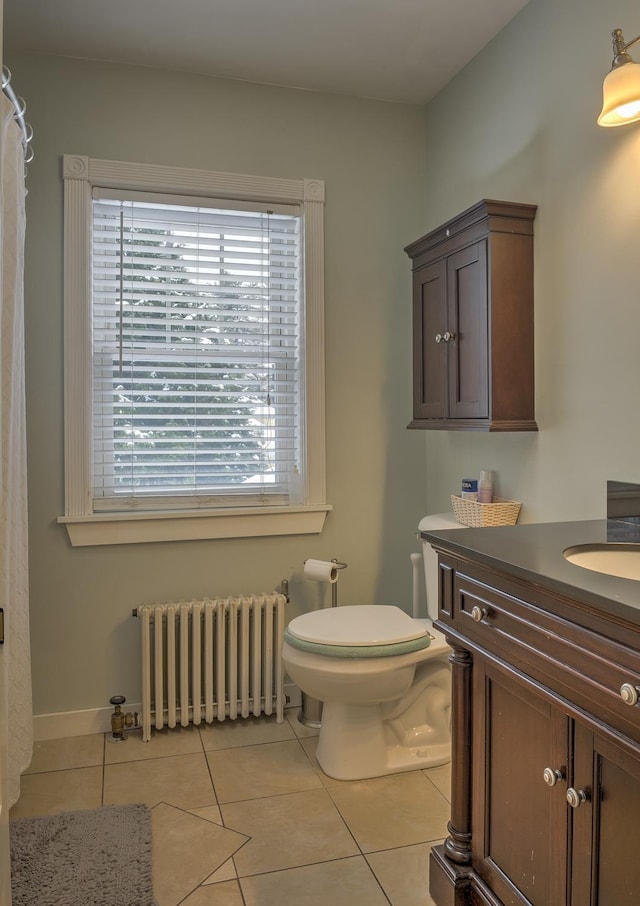 bathroom featuring tile patterned floors, radiator heating unit, vanity, and toilet